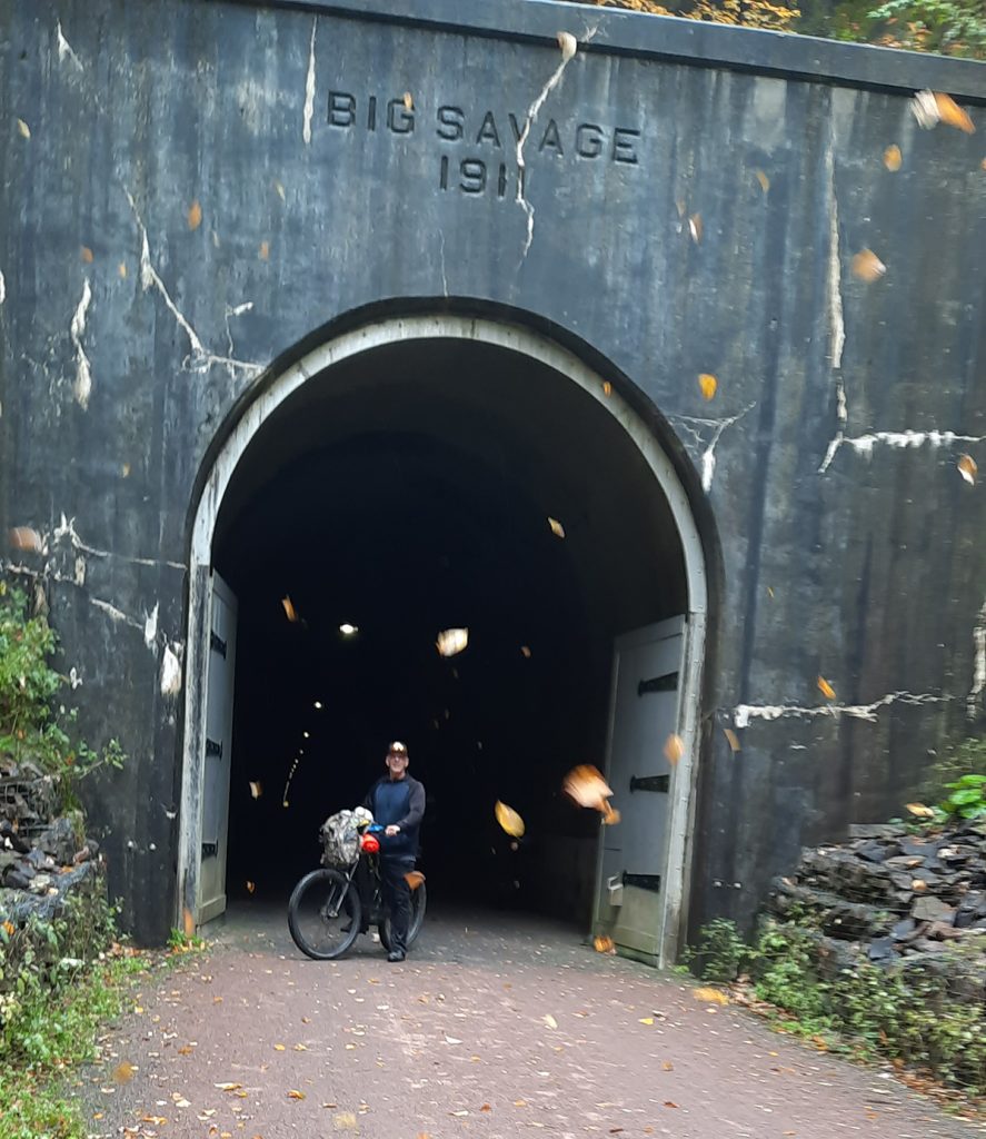 man on bike in front on tunnel