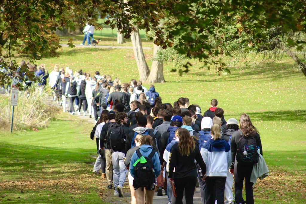 large group of students walking through Kirby Park