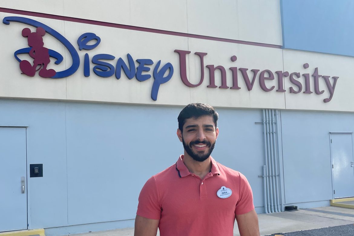 Brahim Hamid Oudjana stands in front of a Disney University sign