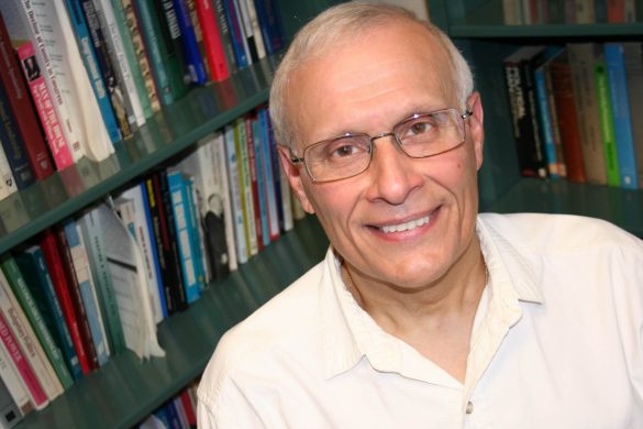 photo of thomas baldino in front of bookcases in his office