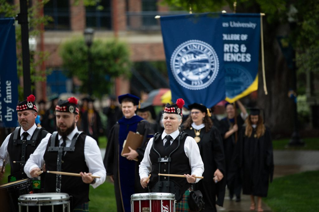 bagpipers play as the graduation procession goes from the henry student center to the commencement ceremony