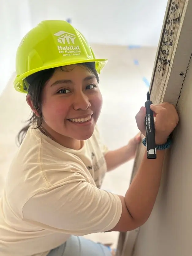 A Wilkes University student volunteering with Habitat for Humanity