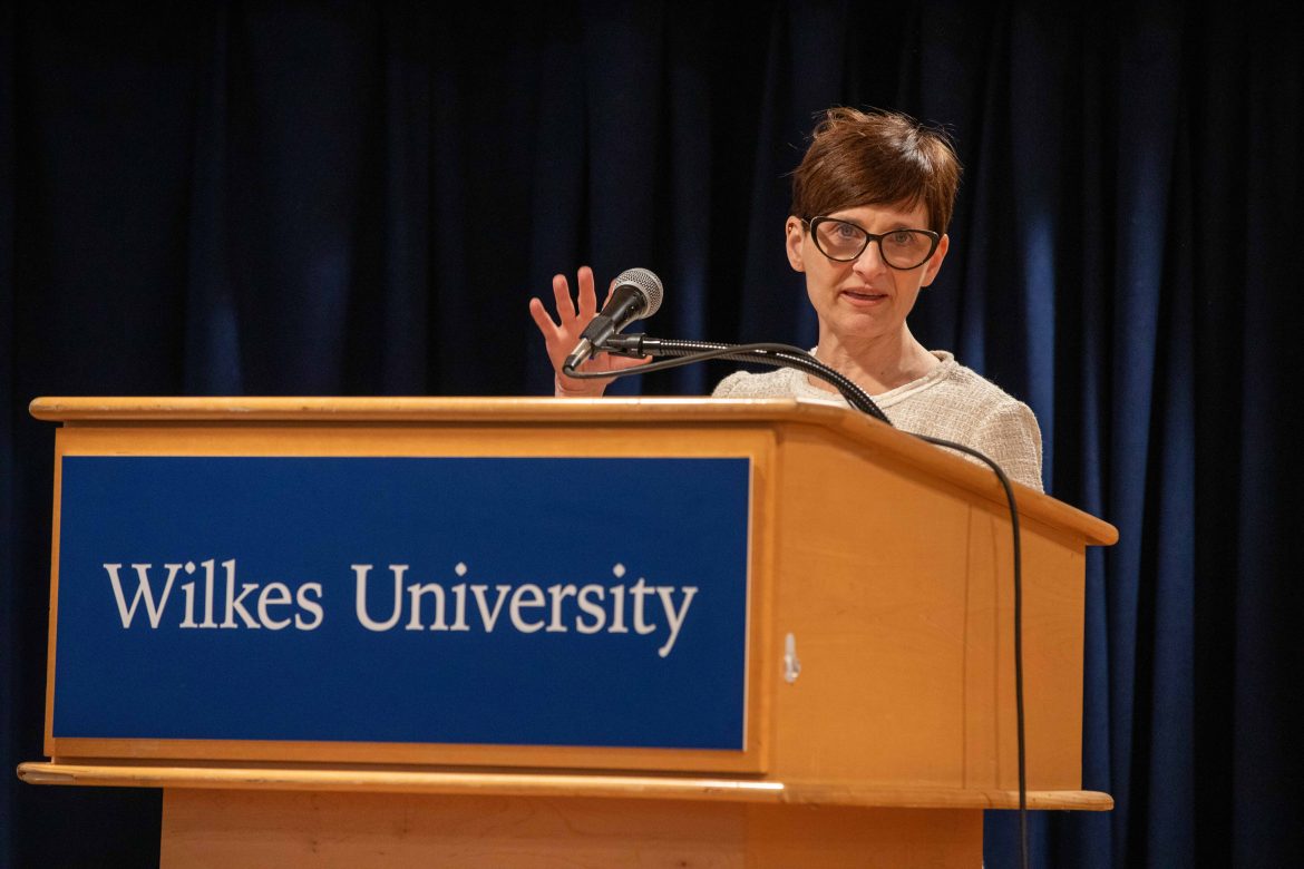 Joyce Victor speaks at a podium