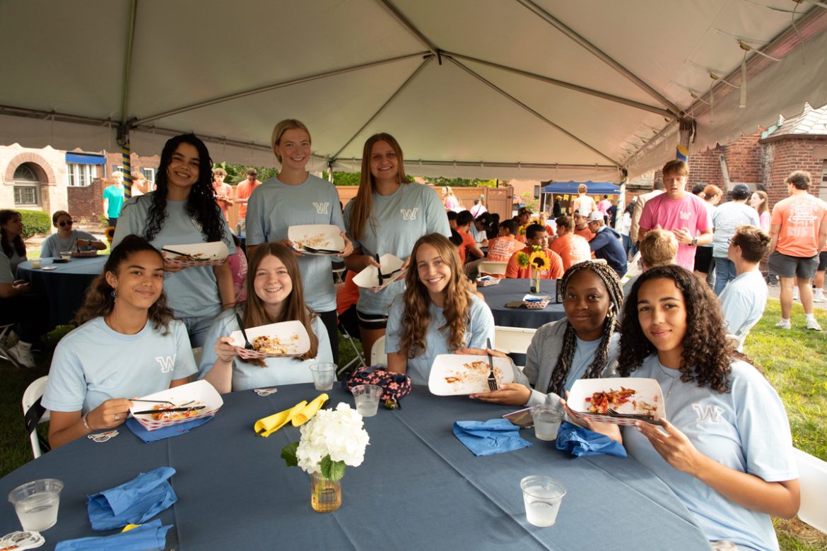 First-year students eating waffles at a table