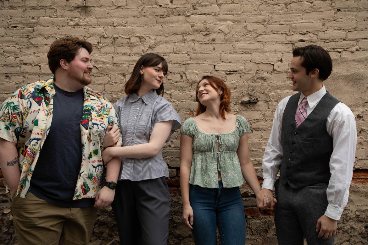 two young couples stand in front of a brick wall