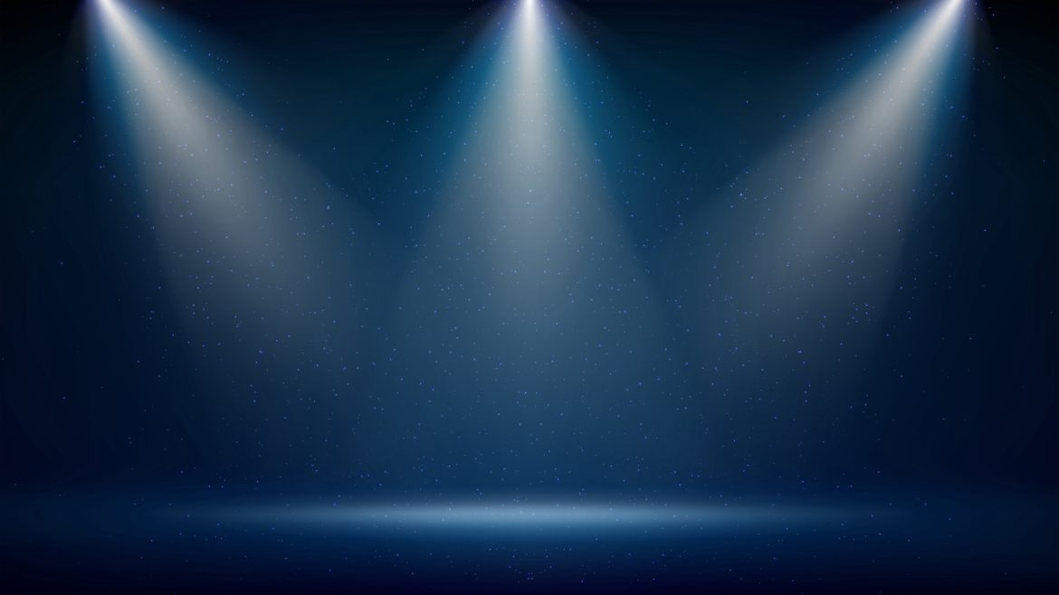 three spotlights shining on a bare stage